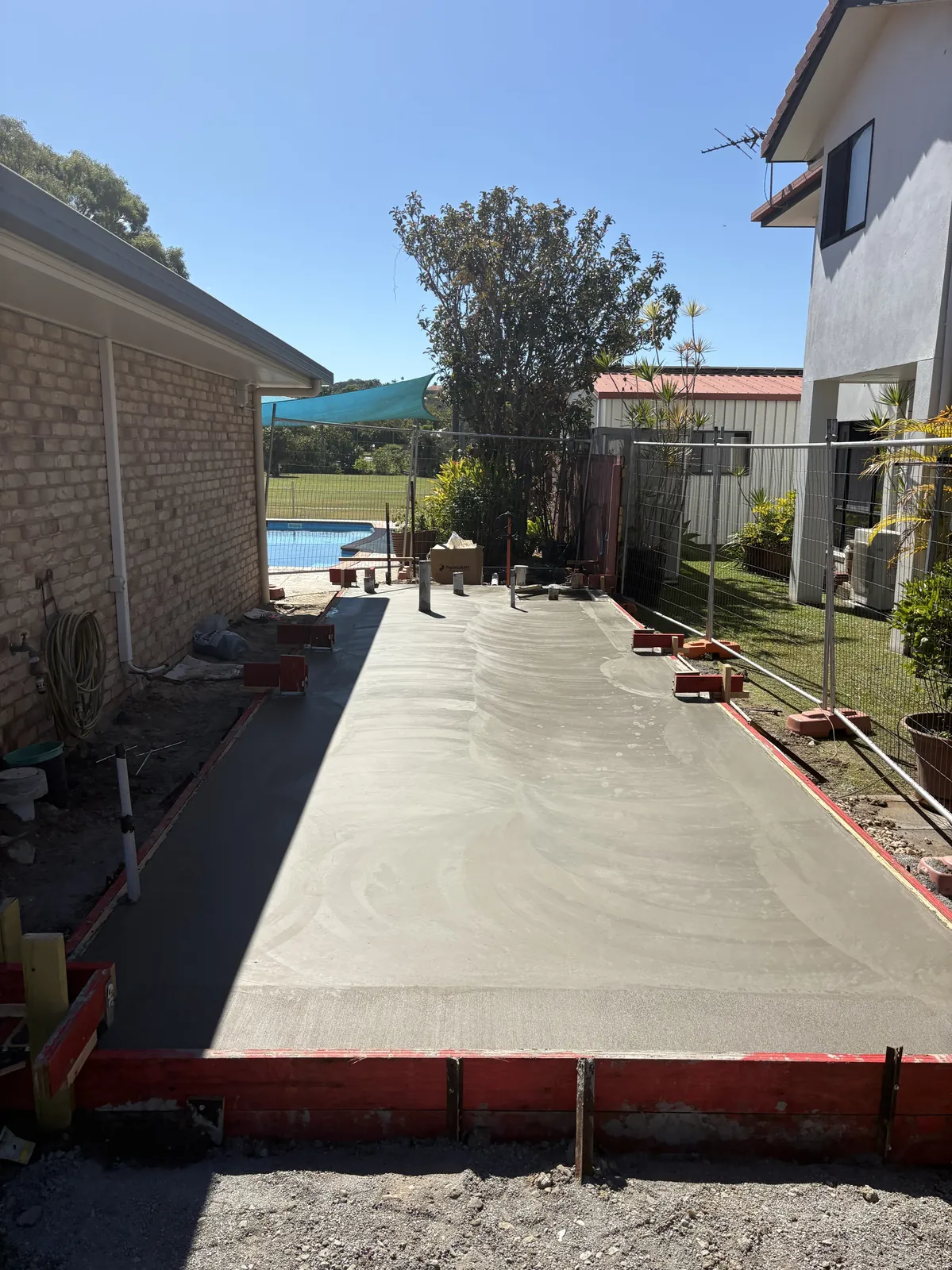 Concrete slab formwork beside a backyard pool in Mackay